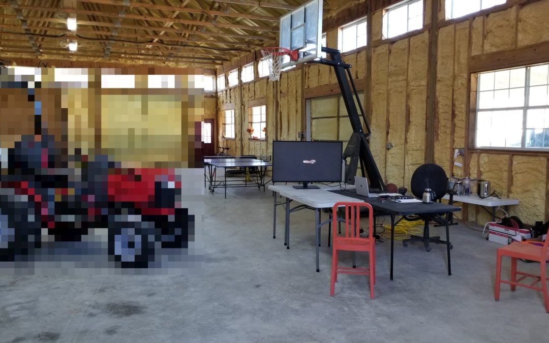Workshop interior with tractor, table, red chairs